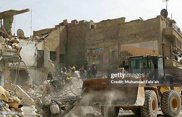 Iraqi rescue workers look through the rubble of a building damaged in a bombing on April 6, 2010 in Alawi area near Haifa street in Baghdad, Iraq....