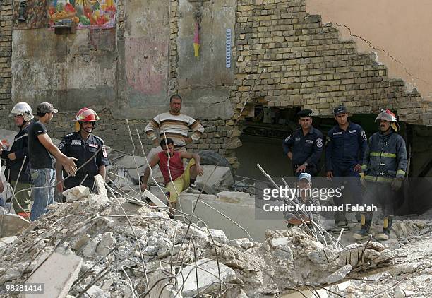 Iraqi rescue workers look through the rubble of a building damaged in a bombing on April 6, 2010 in Alawi area near Haifa street in Baghdad, Iraq....