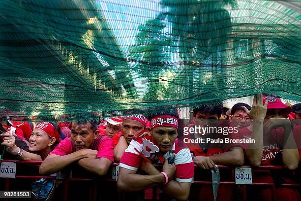 Red shirt supporters of former PM Thaksin Shinawatra's listen to speeches as they defy the government for a fourth day by taking over the streets of...