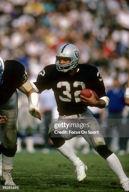 Running Back Marcus Allen of the Los Angeles Raiders plays carries the ball circa mid 1980's during an NFL Football game at the Los Angeles Coliseum...