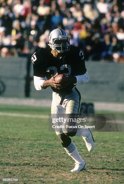 Running Back Marcus Allen of the Los Angeles Raiders plays carries the ball circa mid 1980's during an NFL Football game at the Los Angeles Coliseum...