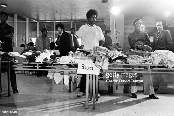 Members of the Black Panther Party stand behind tables ready to distribute free clothing to the public, New Haven, Connecticut, September 28, 1969.