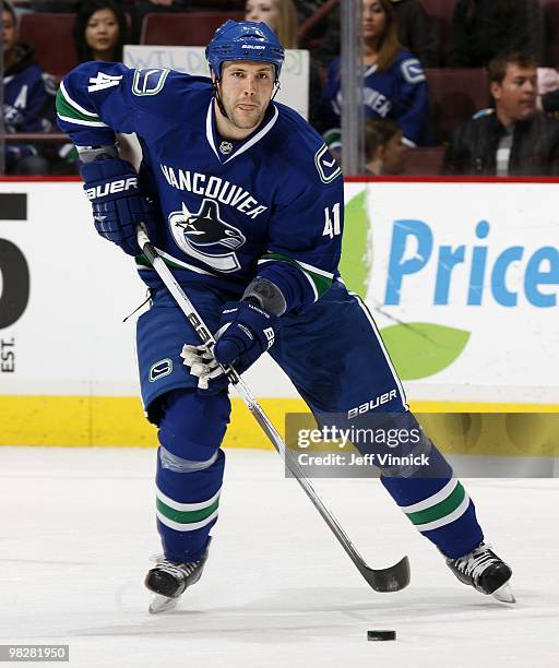 Andrew Alberts of the Vancouver Canucks skates up ice with the puck during their game against the Minnesota Wild at General Motors Place on April 4,...