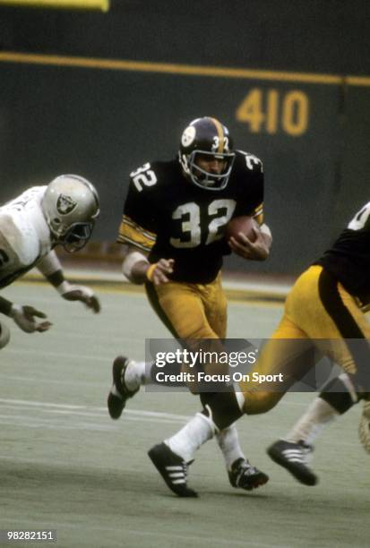 S: Running back Franco Harris of the Pittsburgh Steelers plays carries the ball against the Oakland Raiders circa mid 1970's during an NFL football...