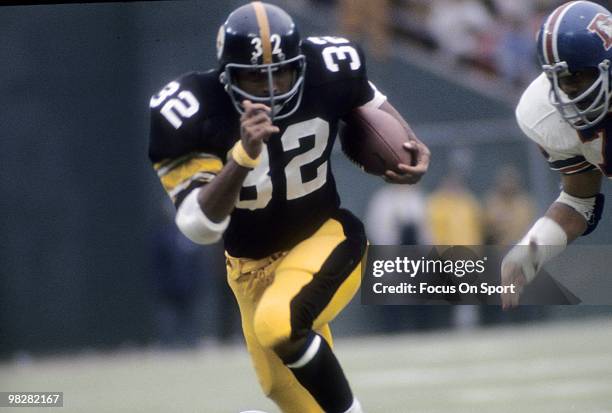 S: Running back Franco Harris of the Pittsburgh Steelers plays carries the ball against the Denver Broncos circa mid 1970's during an NFL football...