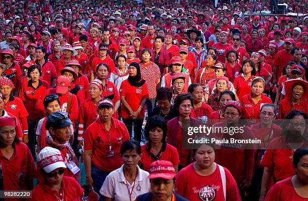 Thousands of Red shirt supporters of former PM Thaksin Shinawatra's stand to salute the King as they defy the government for a fourth day by taking...