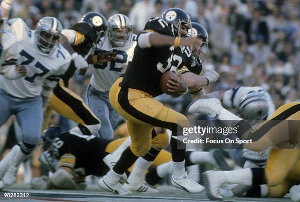 Running Back Franco Harris of the Pittsburgh Steelers plays carries the ball against the Dallas Cowboys on January 18, 1976 during Super Bowl X at...