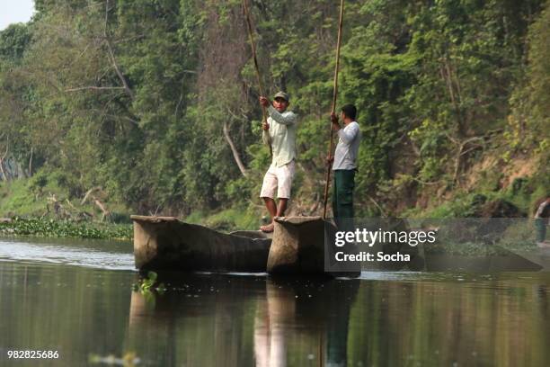 nepalese local man traveling by boat on a rapti river in a national park chitwan - nepal drone stock pictures, royalty-free photos & images