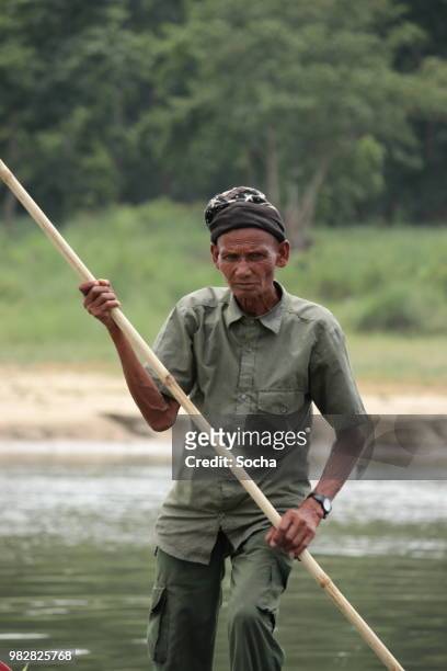 nepalese local man traveling by boat on a rapti river in a national park chitwan - nepal drone stock pictures, royalty-free photos & images
