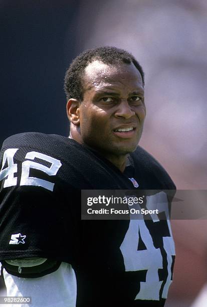 Defensive Back Ronnie Lott of the Los Angeles Raiders watches the action from the sidelines September 15, 1991 during an NFL football game between...