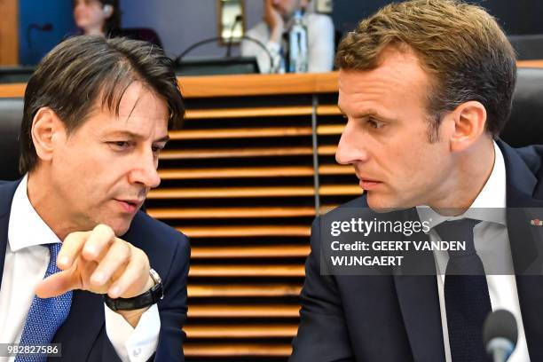 French President Emmanuel Macron speaks with Italian Prime Minister Giuseppe Conte during a round table meeting at an informal EU summit on migration...