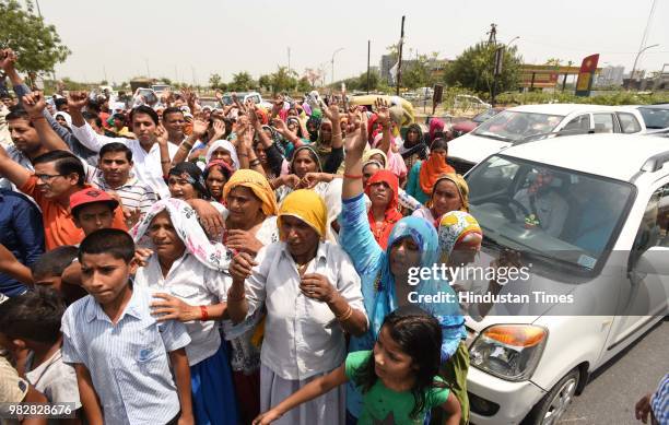 Villagers and residents protest against the dumping ground at sector 123, on June 24, 2018 in Noida, India. The National Green Tribunal issued an...