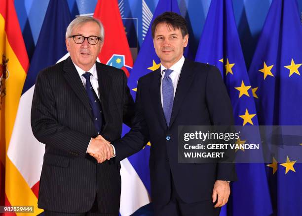 European Commission President Jean-Claude Juncker speaks with Italian Prime Minister Giuseppe Conte during an informal EU summit on migration issues...