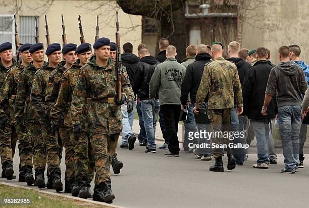 Soldiers of the German Bundeswehr march past conscripts who had just arrived on their first day of compulsory military service at the Julius Leber...