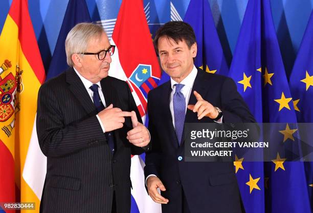 European Commission President Jean-Claude Juncker speaks with Italian Prime Minister Giuseppe Conte during an informal EU summit on migration issues...