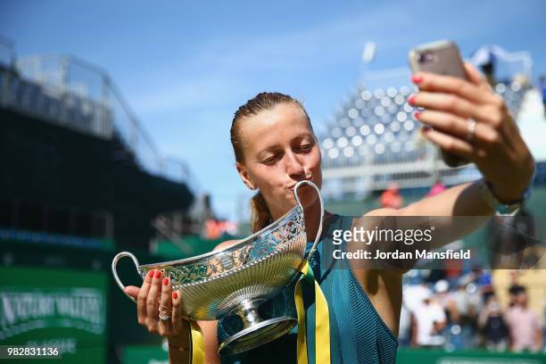 Petra Kvitova of the Czech Republic kisses the Trophy as she poses for a selfie after her singles Final match against Magdalena Rybarikova of...