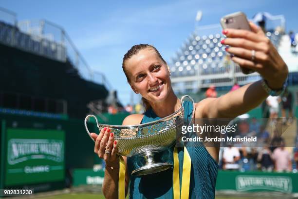 Petra Kvitova of the Czech Republic poses for a selfie with the Trophy after her singles Final match against Magdalena Rybarikova of Slovakia during...