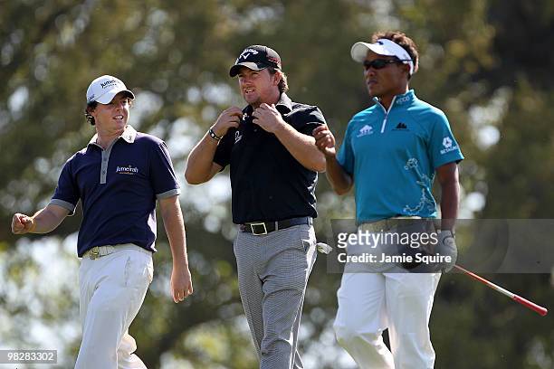 Rory McIlroy and Graeme McDowell of Northern Ireland and Thongchai Jaidee of Thailand walk off a tee box during a practice round prior to the 2010...