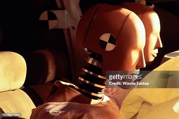 crash-test dummies inside car with inflated airbags, close-up - airbag stock-fotos und bilder