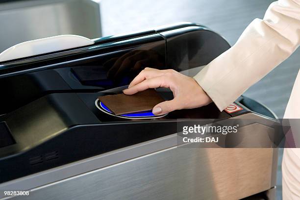 woman walking through automatic ticket wicket at station, close up - 改札 ストックフォトと画像