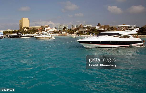 Boats sit docked on the water in Cancun, Mexico, on Saturday, April 3, 2010. Passenger traffic at the Cancun airport increased 1.1 percent in March...