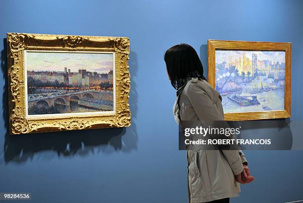 Person looks at paintings presented during the exhibition "Impressionism along the Seine" on March 31, 2010 in Giver, as part of the Normandie...