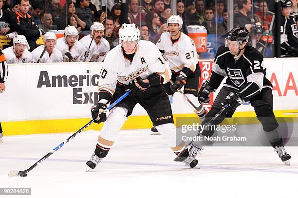 Corey Perry of the Anaheim Ducks skates with the puck against Alexander Frolov of the Los Angeles Kings on April 3, 2010 at Staples Center in Los...