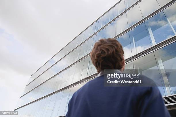 germany, hamburg, businessman in front of office building, rear view - low angle view ストックフォトと画像