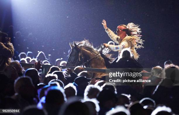 June 2018, Germany, Bad Segeberg: The actor Jan Sosniok as Winnetou riding a horse through the spectator terraces at the premiere of 'Winnetou und...
