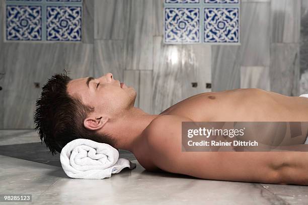 turkey, bare-chested man lying on back, eyes closed - bare back stock-fotos und bilder
