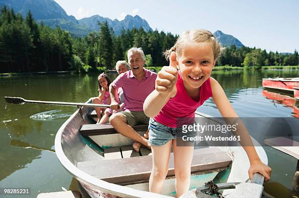 italy, south tyrol, grandparents and children (6-7) (8-9) in rowing boat on lake, portrait - girl rowing boat photos et images de collection