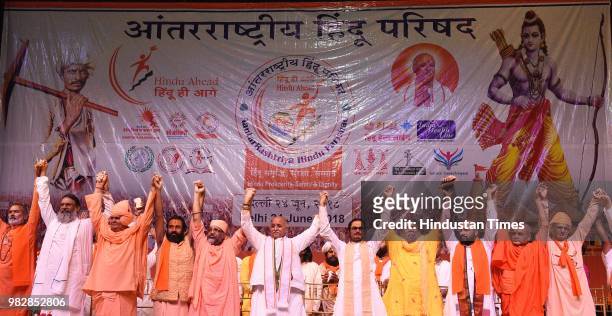 Former Vishwa Hindu Parishad leader Pravin Togadia joins hands with other leaders during the launch of his new outfit International Hindu Council at...