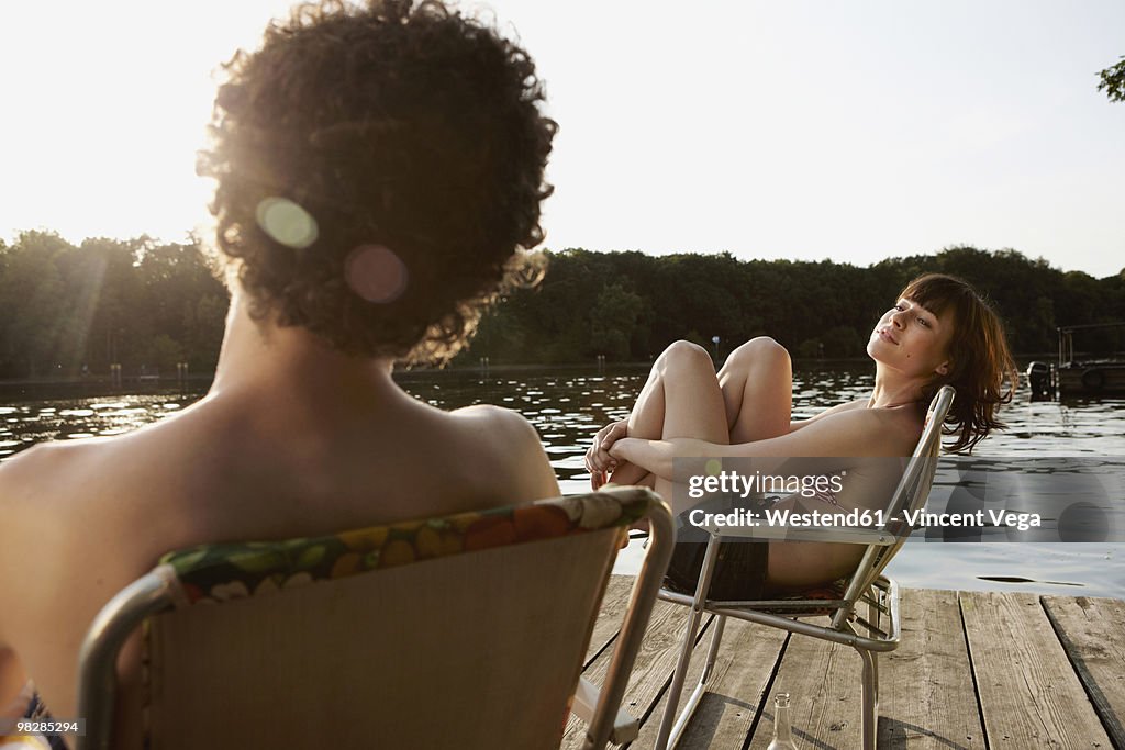Germany, Berlin, Young couple relaxing on chairs