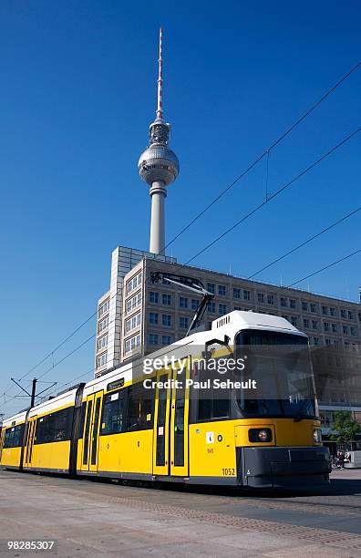 germany, berlin, yellow tram, tv tower in background - tram stock-fotos und bilder