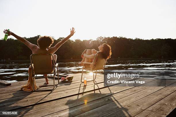 germany, berlin, young couple relaxing on chairs - ponton bois photos et images de collection