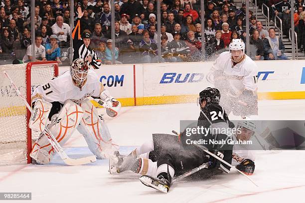 Alexander Frolov of the Los Angeles Kings is taken to the ice in front of Curtis McElhinney of the Anaheim Ducks on April 3, 2010 at Staples Center...