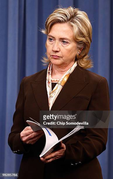 Secretary of State Hillary Clinton holds a copy of the new Nuclear Posture Review during a news briefing about the report at the Pentagon April 6,...