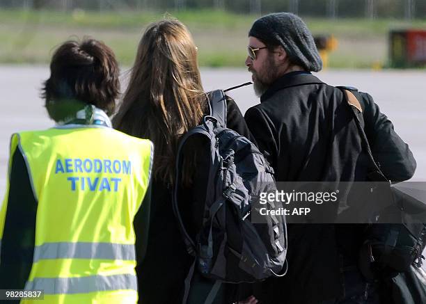Actor Brad Pitt accompanied by US actress and UNHCR goodwill ambassador Angelina Jolie enter a plane in Montenegrin coastal town of Tivat, 60...