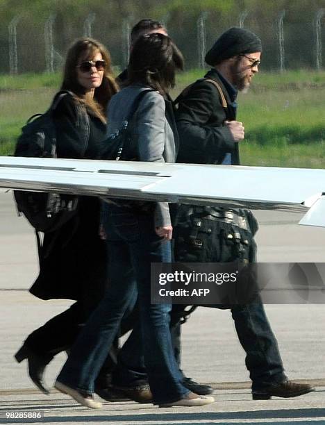 Actor Brad Pitt accompanied by US actress and UNHCR goodwill ambassador Angelina Jolie enters a plane, in Montenegrin coastal town of Tivat, 60...