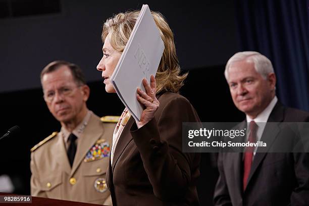 Secretary of State Hillary Clinton holds up a copy of the Nuclear Posture Review during a news conference with Chairman of the Joint Chiefs of Staff...