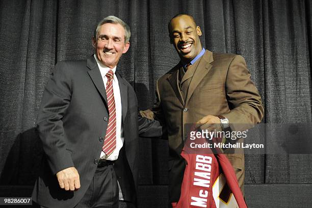 Mike Shanahan, head coach of the Washington Redskins presents Donovan McNabb with his new jersey during a press conference on April 6, 2010 at...