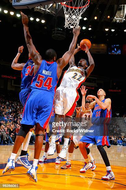 Anthony Morrow of the Golden State Warriors shoots over Jason Maxiell and Charlie Villanueva of the Detroit Pistons during the game on February 27,...