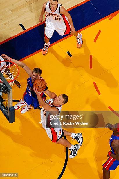 Andris Biedrins of the Golden State Warriors goes to the basket against Jonas Jerebko of the Detroit Pistons during the game on February 27, 2009 at...