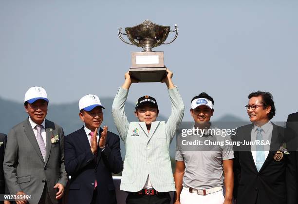 Choi Min-Chul of South Korea lifts the Championship's trophy during a ceremony following the final round of the Kolon Korea Open Golf Championship at...