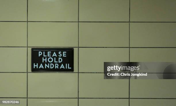 please hold handrail sign safety warning wall - ttc stock pictures, royalty-free photos & images