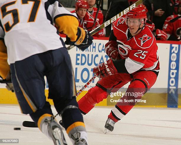 Joni Pitkanen of the Carolina Hurricanesskates the puck into the defensive zone of the Buffalo Sabres during the NHL game on March 21, 2010 at the...