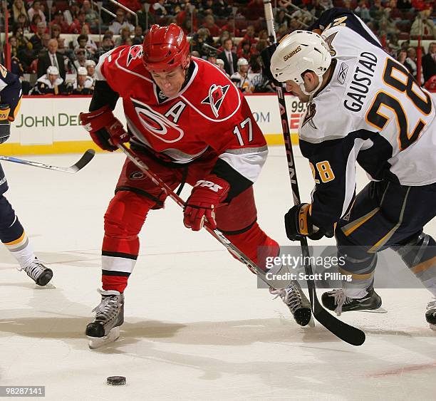 Rod Brind'Amour of the Carolina Hurricanes rushes to the puck after beating Paul Gaustard of the Buffalo Sabres in a faceoff during the NHL game on...