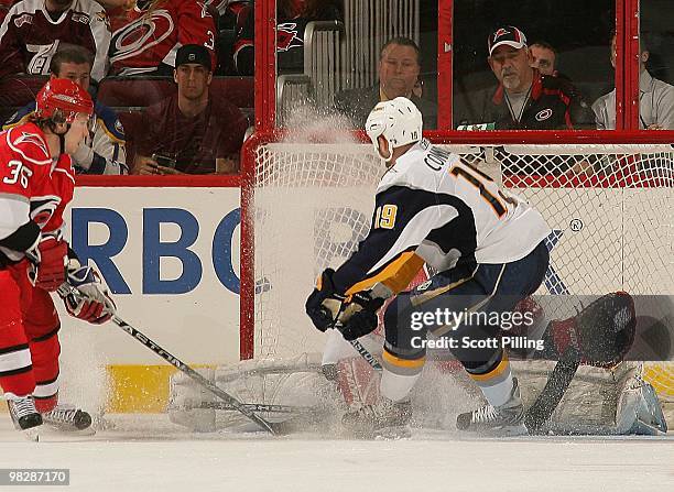 Manny Legace of the Carolina Hurricanes drops down to stop a shot on goal by Tim Connolly of the Buffalo Sabres during the NHL game on March 21, 2010...