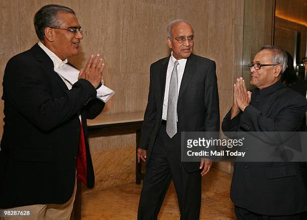 HarperCollins director and India Today Group editor-in-chief Aroon Purie greets finance minister Pranab Mukherjee as Maruti chairman and author RC...