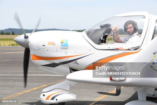 Gerald Egea thumbs up in his plane on June 24, 2018 before taking off from Bergerac airport for a 45 mn flight to Rodez to end his 21-day tour of...